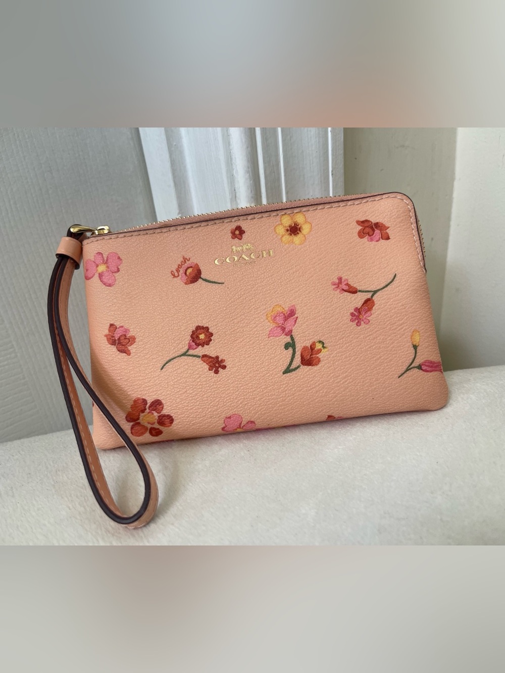 Coach Peach Floral Wristlet with Gold Logo